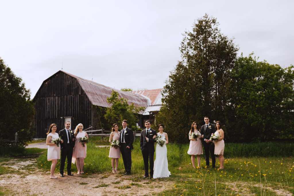 wedding party outside of old barn