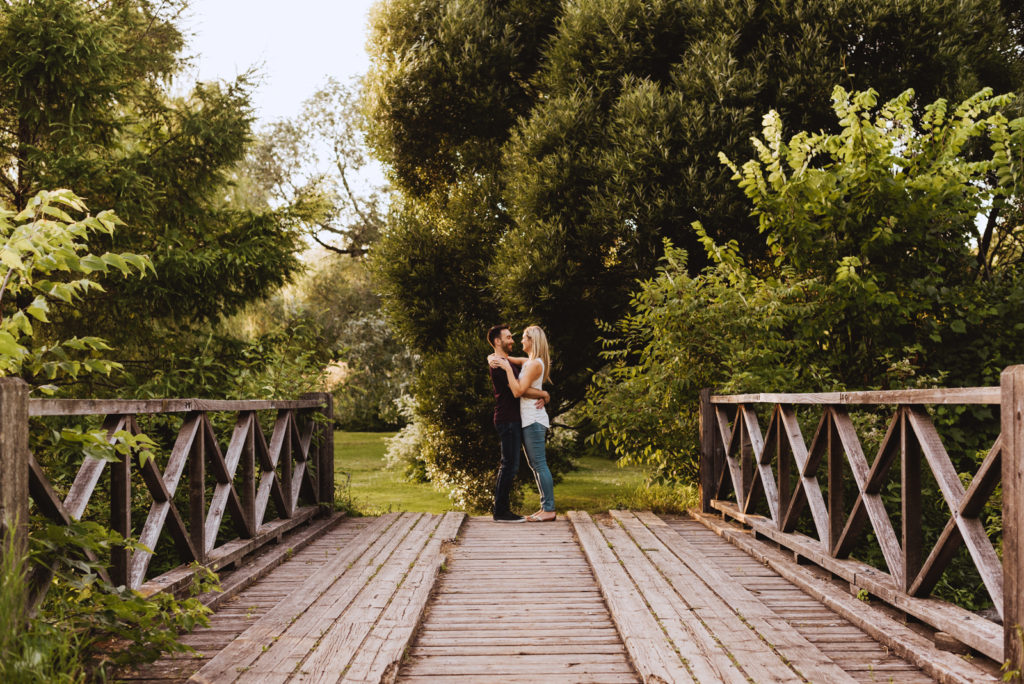 engaged couple on a wooden bridge