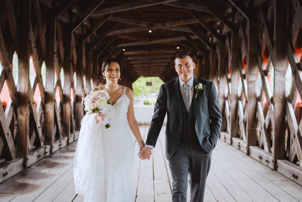 bride and groom walking together on the wakefield bridge
