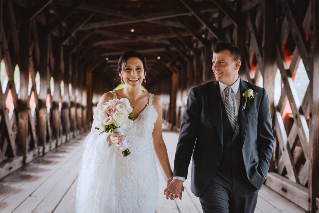 bride and groom walking together on the wakefield bridge