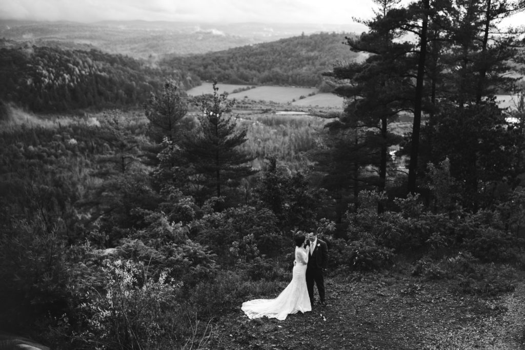bride and groom overlooking gatineau hills at Le Belvedere