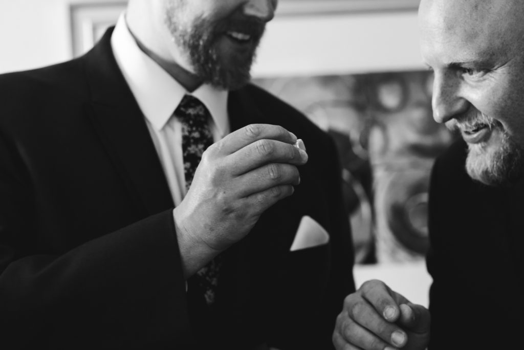 groom showing off his new ring from his bride