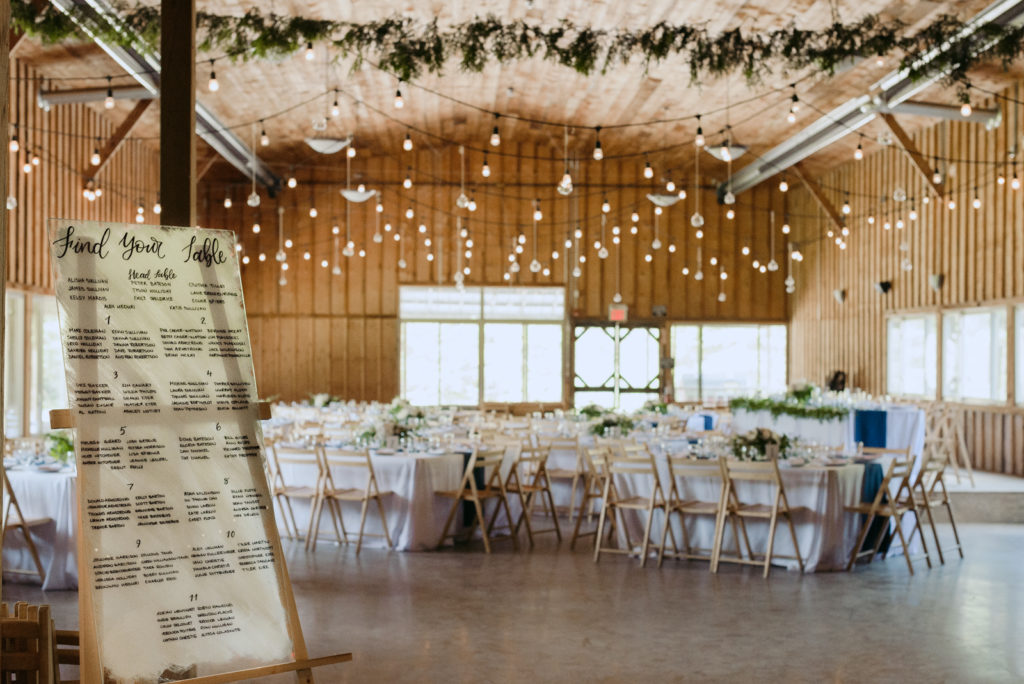 wedding reception space with greenery and edison bulbs at saunders farm