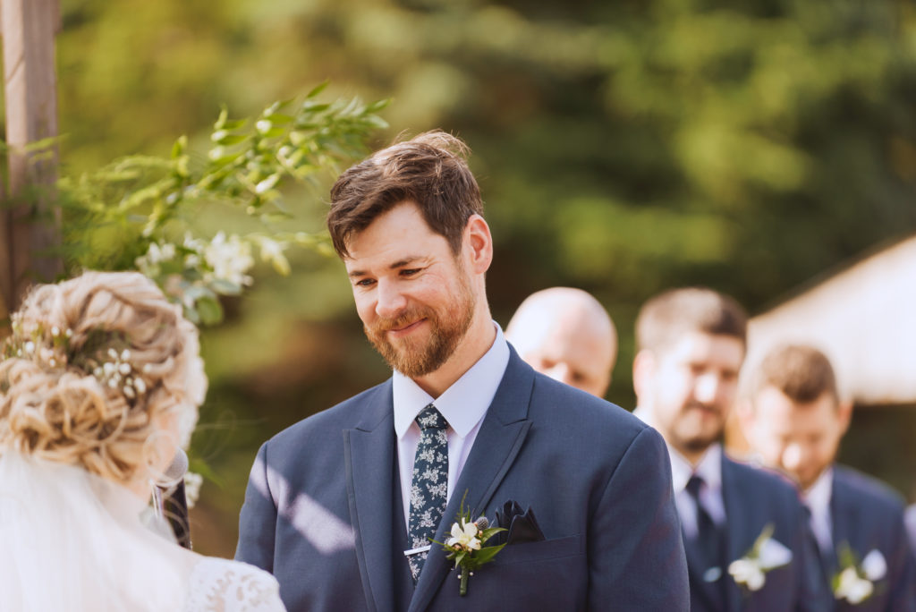 groom smiling at bride during the wedding ceremony
