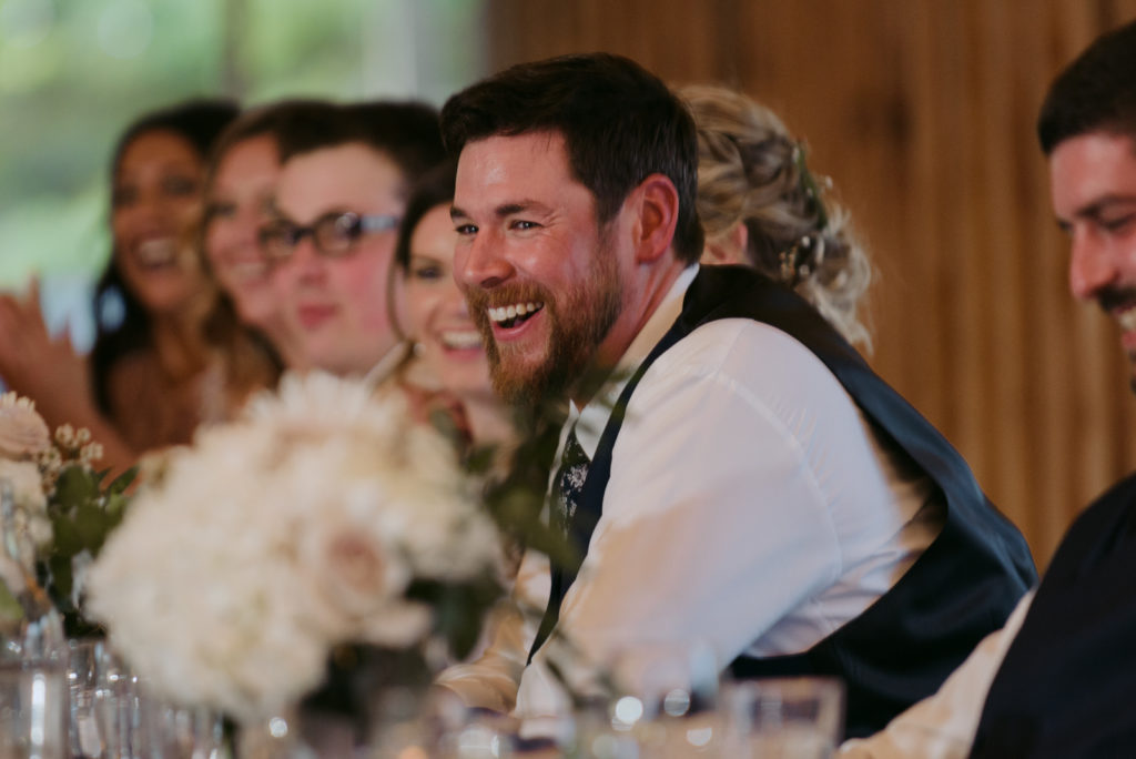 groom laughing at best man speech