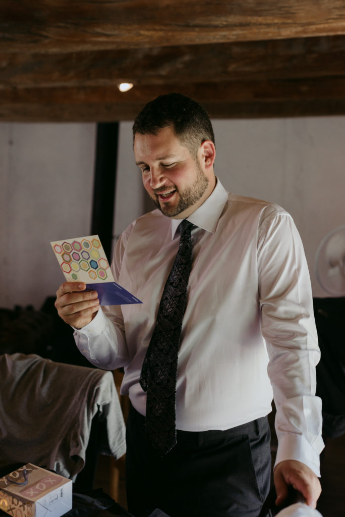 groom reading a card from his bride