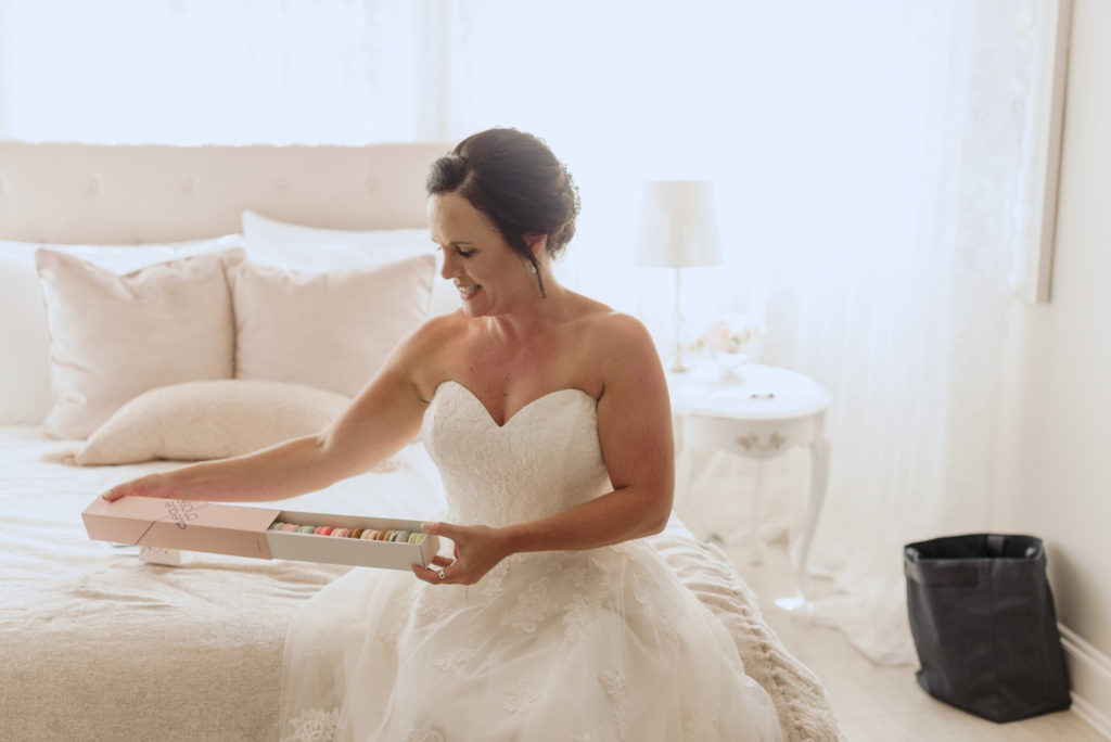 bride opening macaroons from the groom
