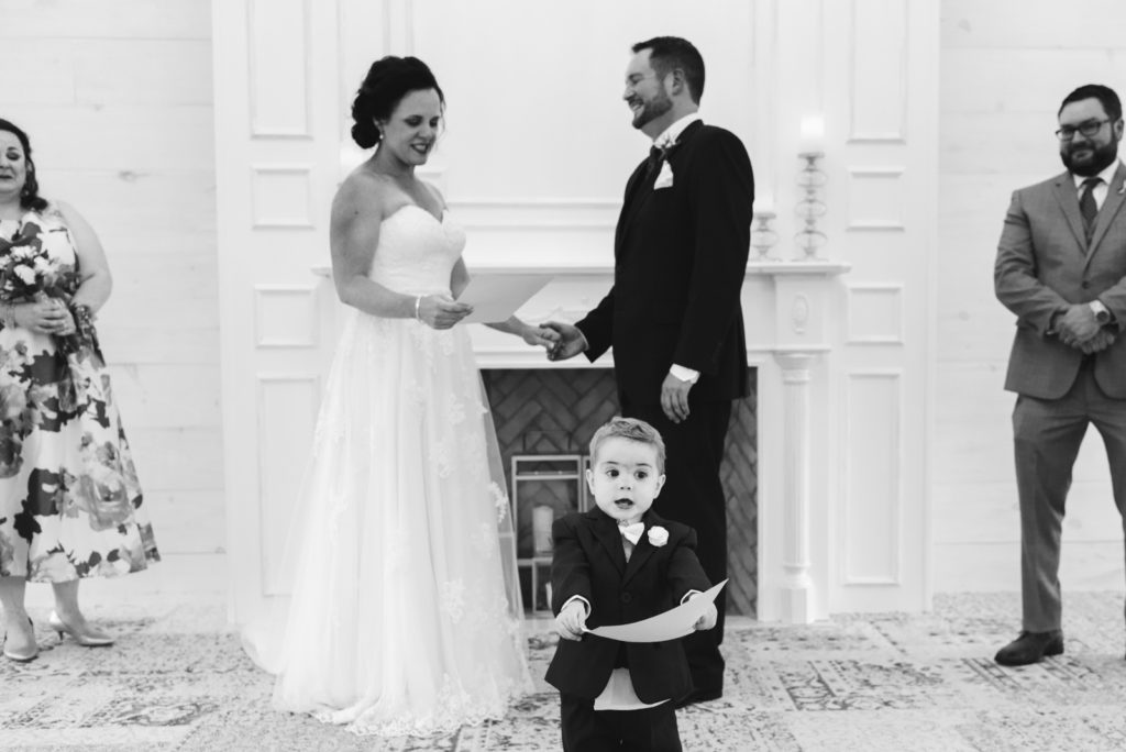 bride and groom's son holding wedding vows