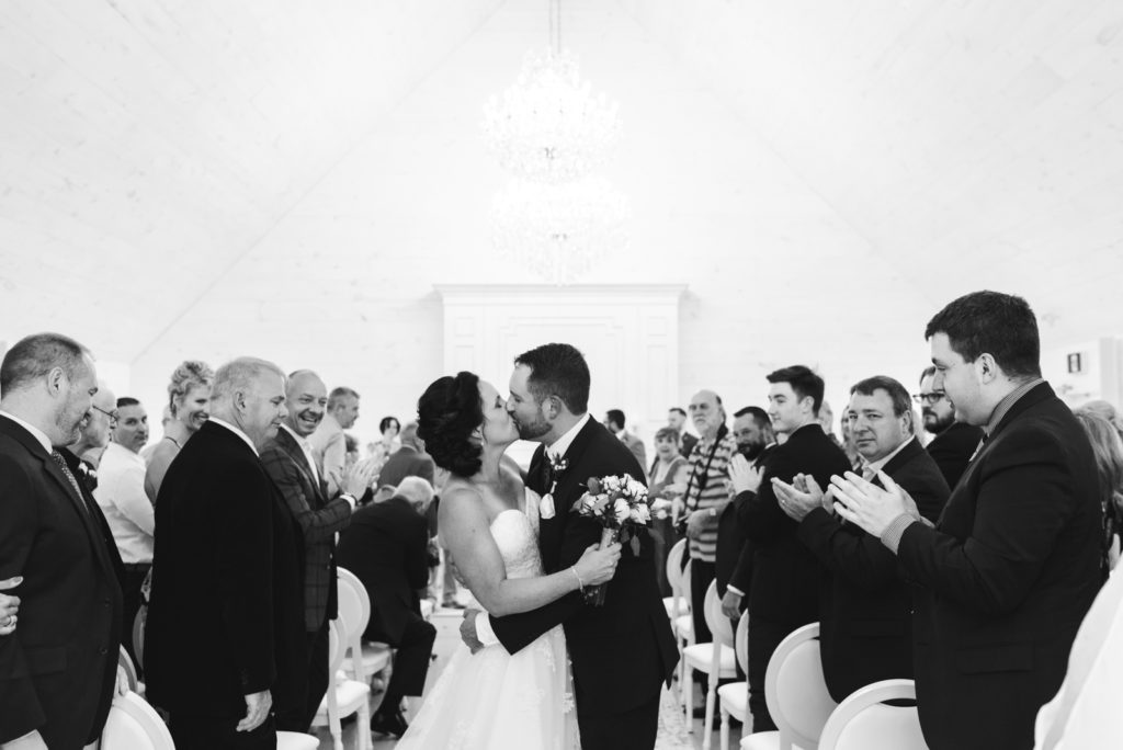 bride and groom recessional kiss