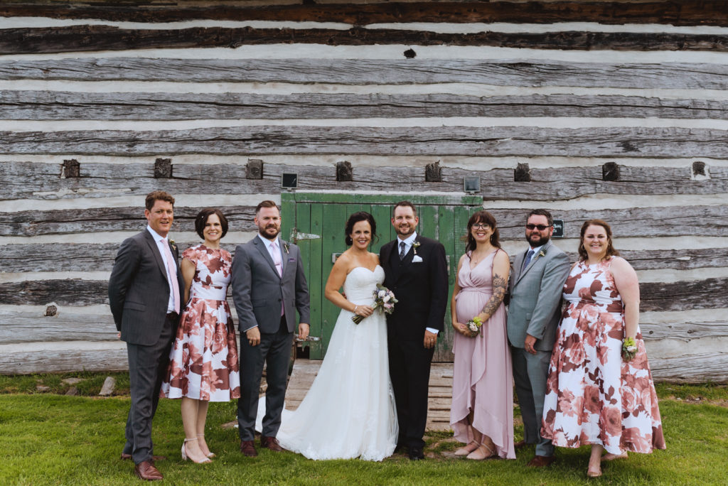wedding party in front of old barn