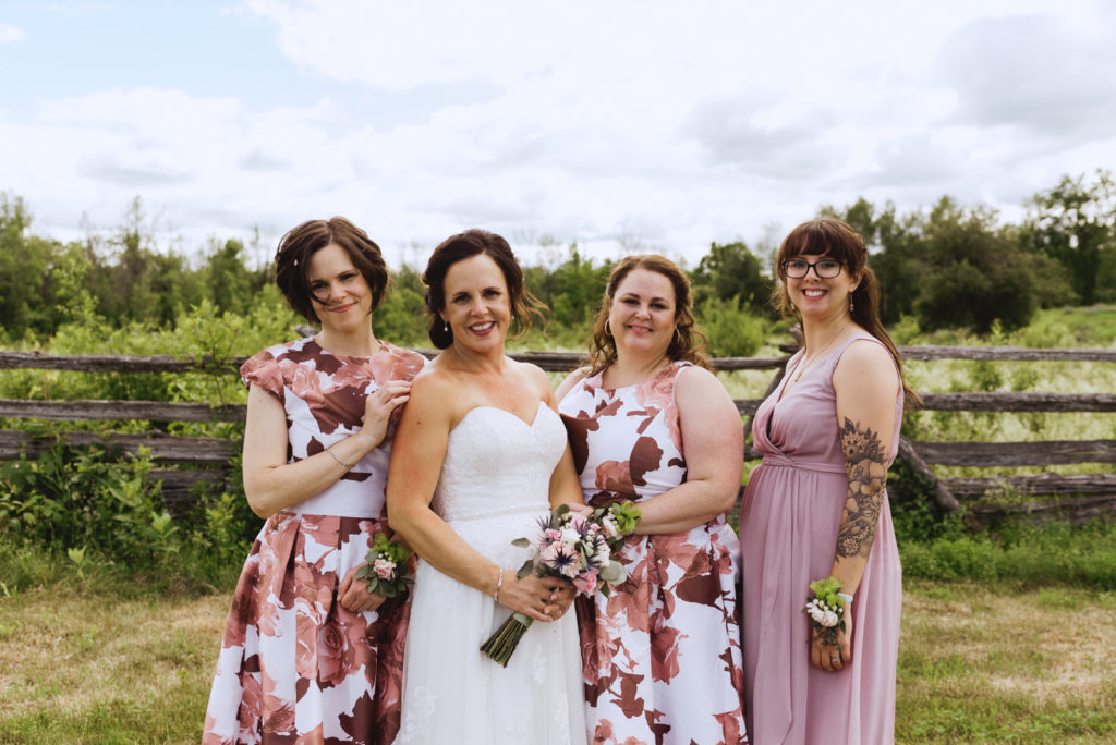 bride and bridesmaids in farm field