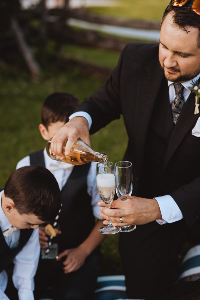 groom pouring champagne