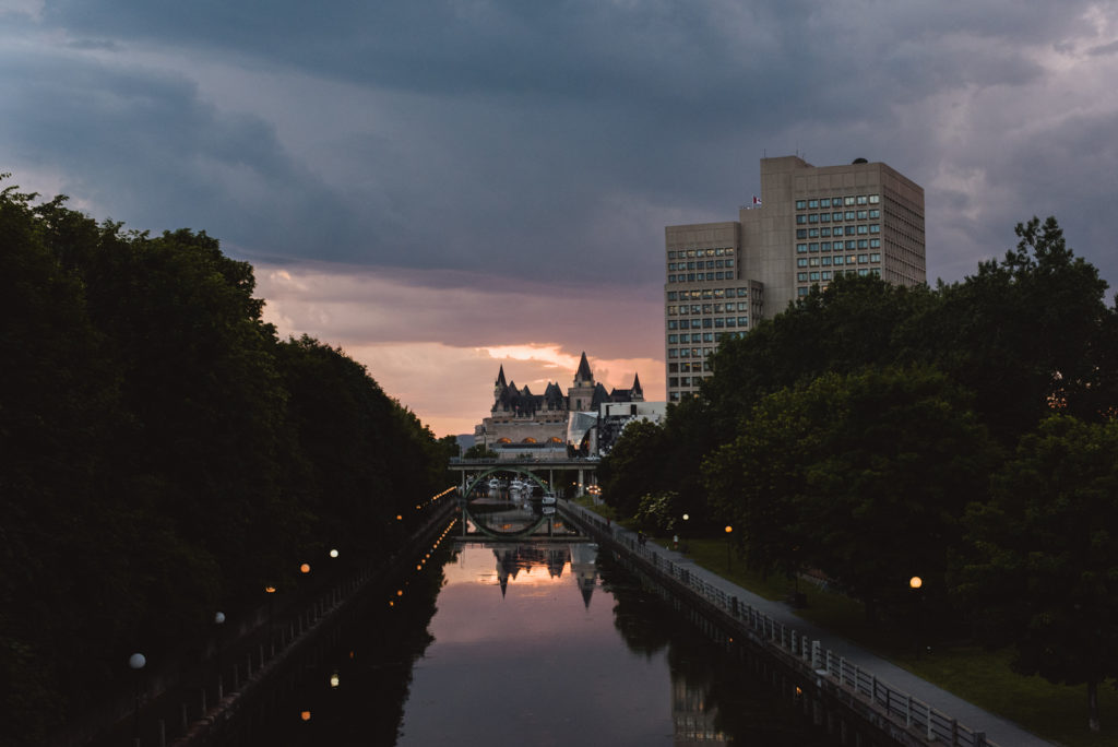 view of the chateau laurier over the canal at sunset