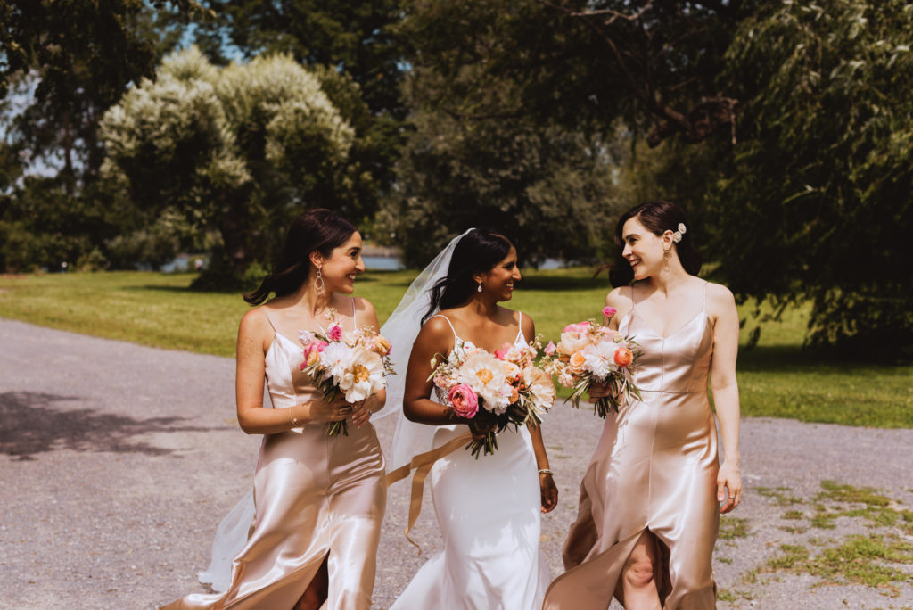 bride and her bridesmaids walking around the arboretum