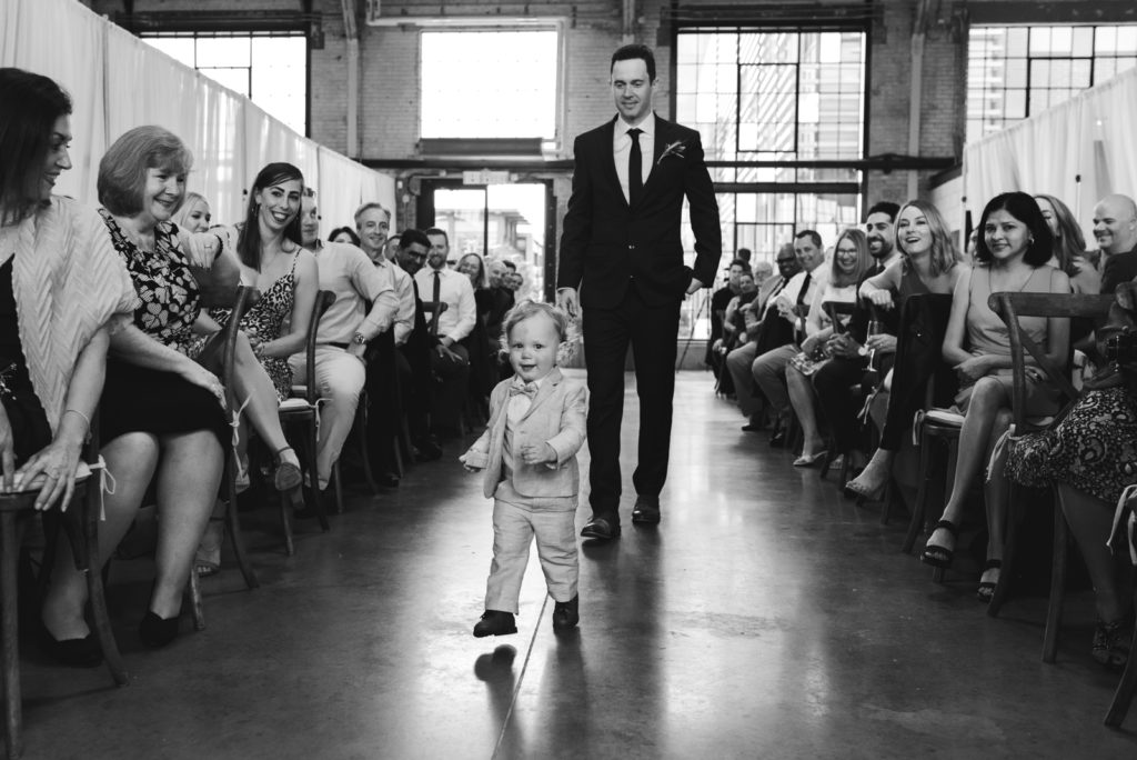ring bearer running down the aisle at the Horticulture Building