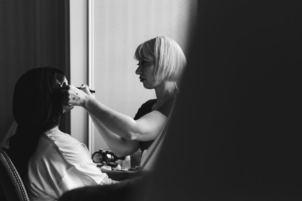 natalie peachy makeup artist doing the bride's makeup in hotel room