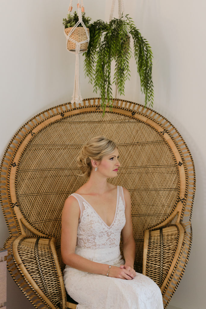 bride sitting in wicker rattan chair at the June Motel
