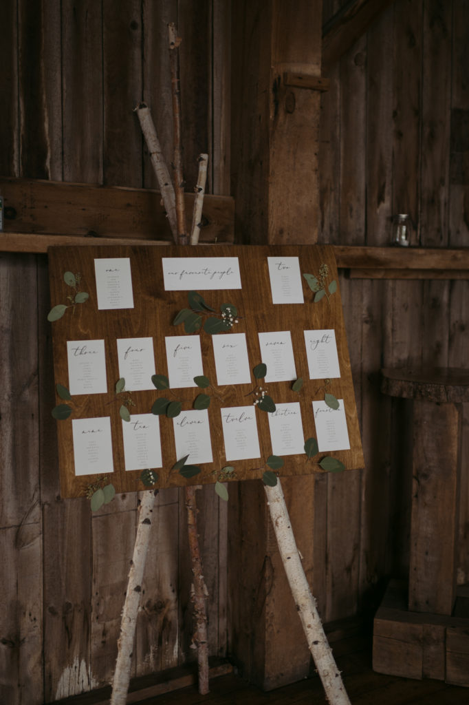 wooden seating chart on birch tree