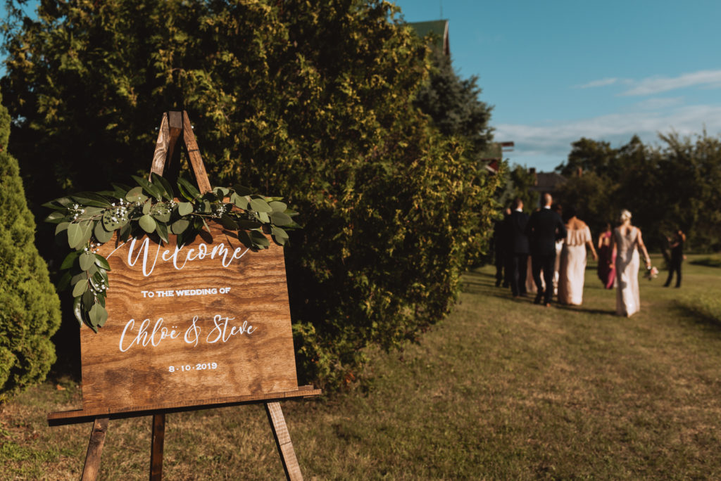 wooden welcome sign at wedding