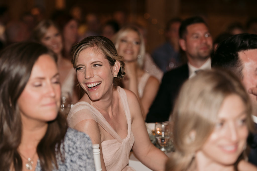 bridesmaid laughing during speeches