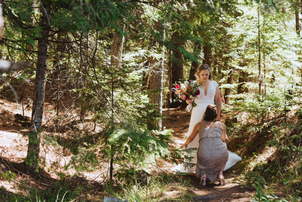 maid of honour prepping bride for first look in forest
