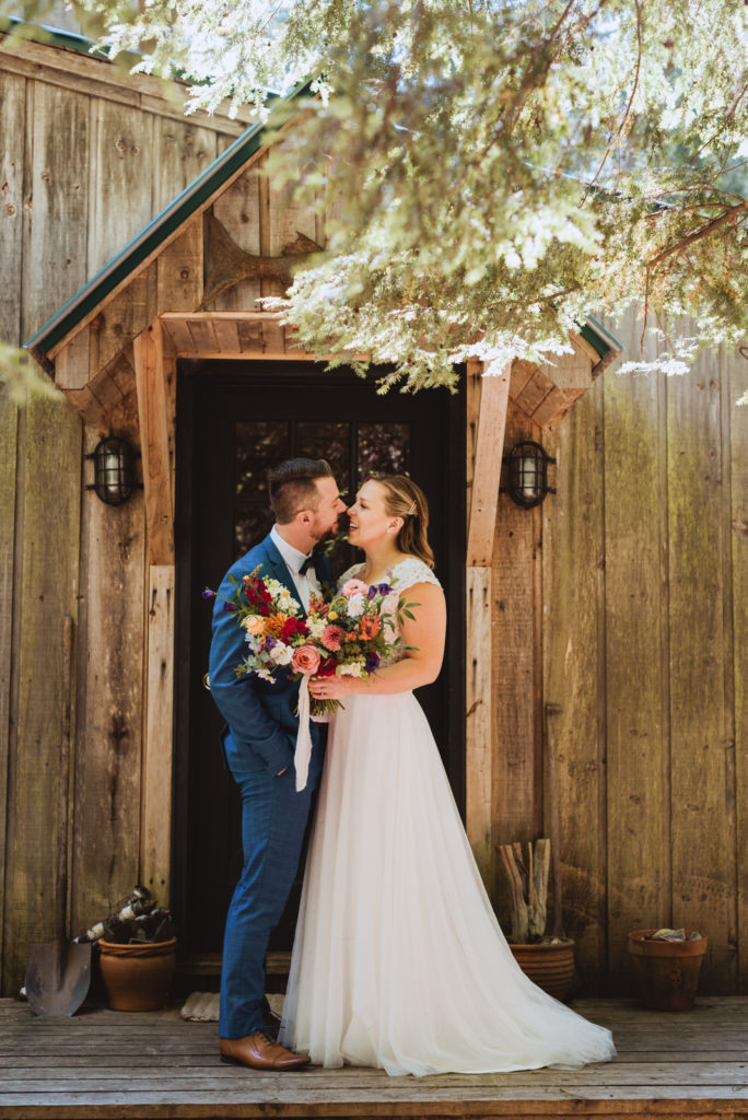 bride and groom outside cottage door