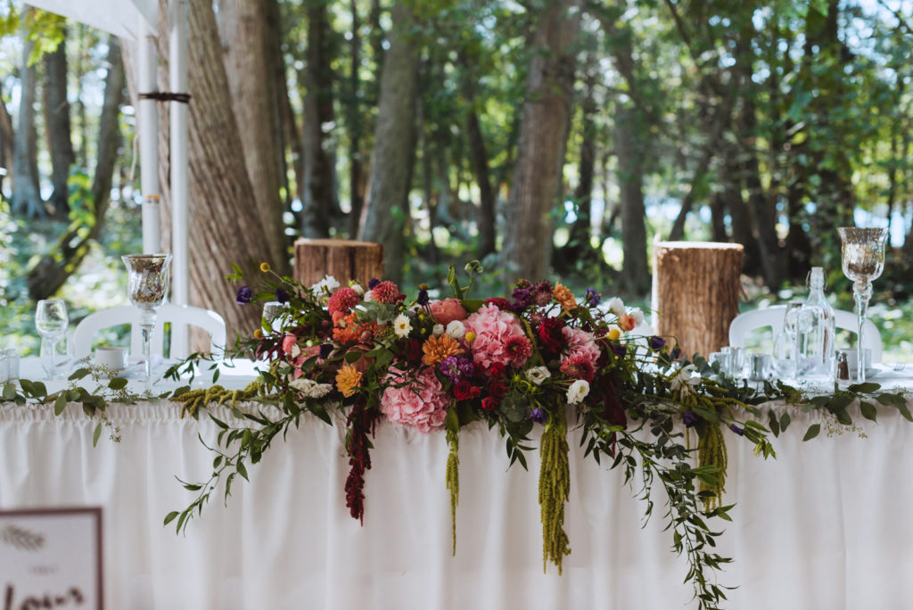 florals on head table in the forest