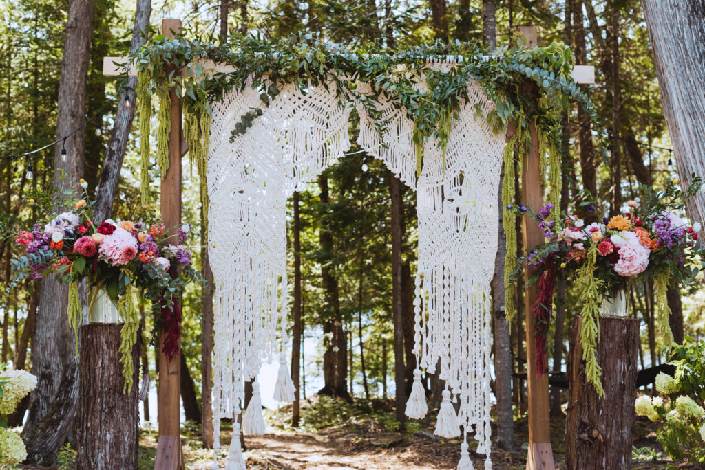 wedding ceremony arch with macrame and flowers