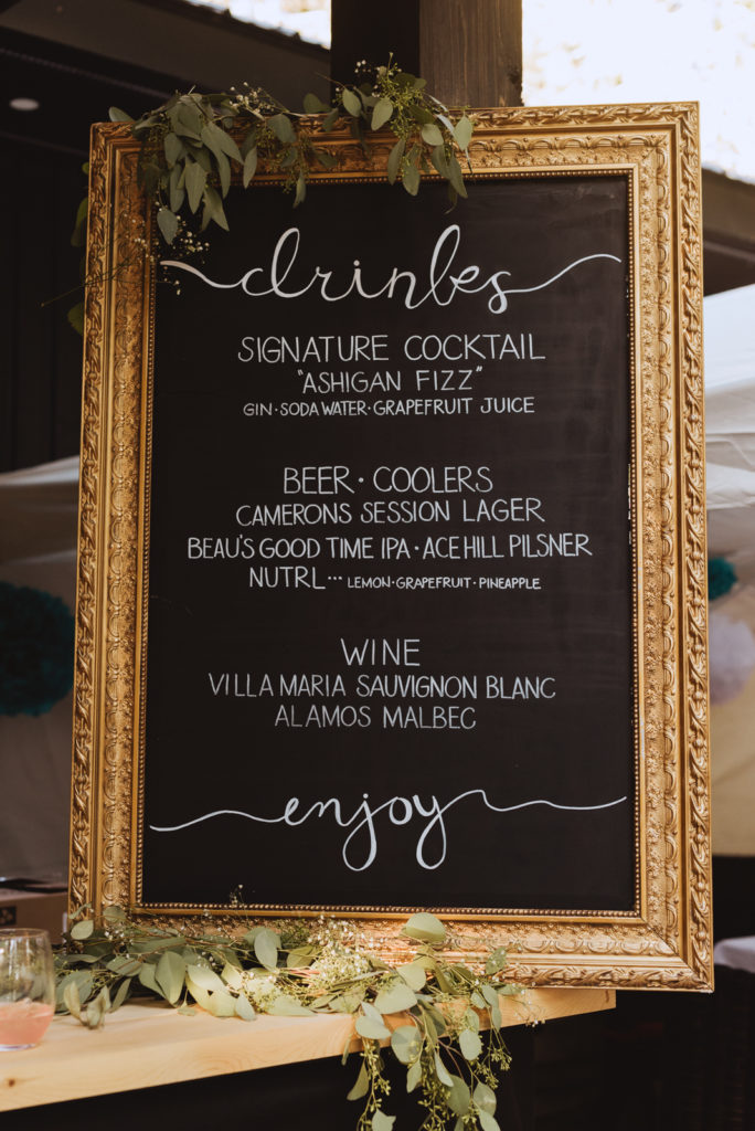 cocktail menu on chalkboard at wedding