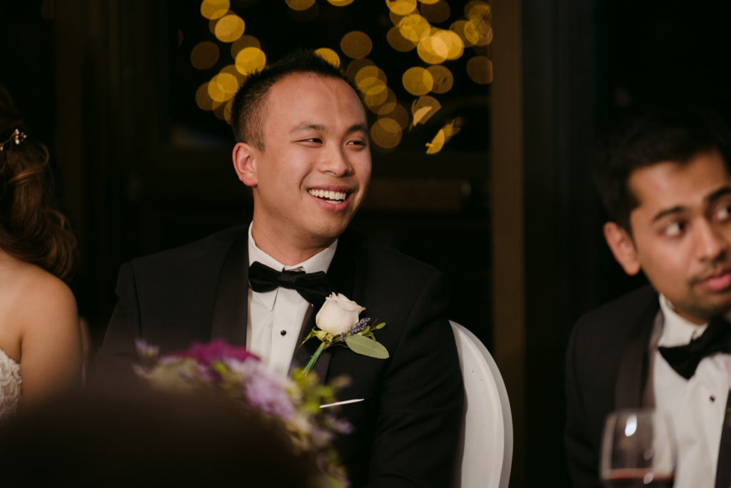groom laughing during speeches