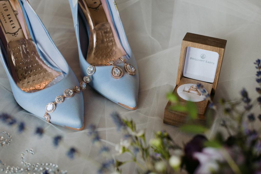 wedding details with flowers and blue shoes