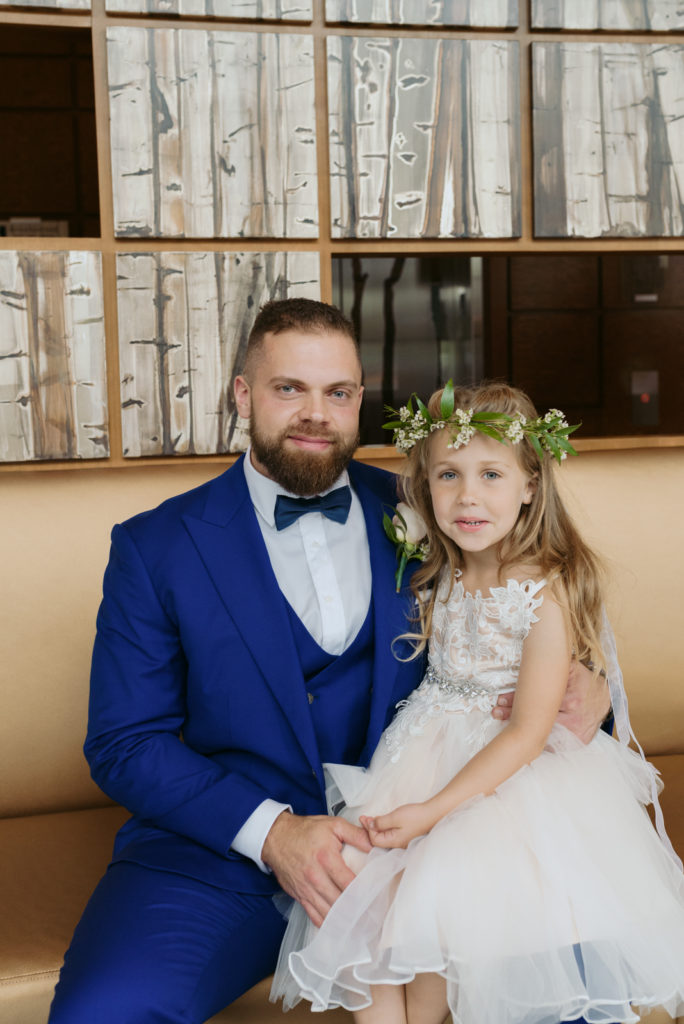 groom and flower girl smiling for the camera