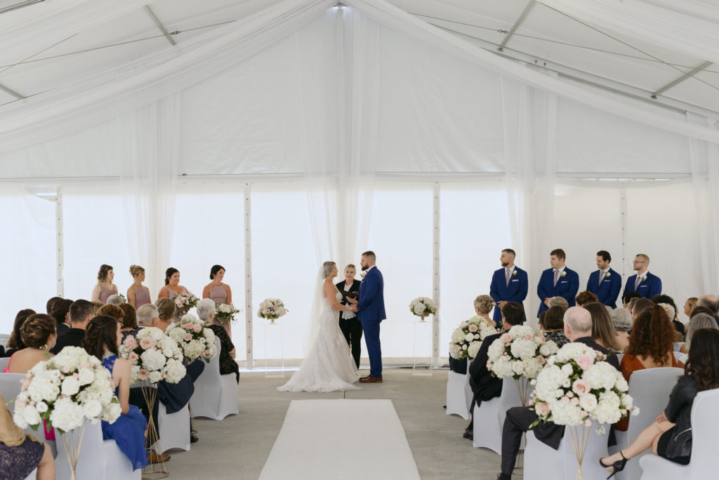 wedding ceremony underneath white tent at the brookstreet hotel