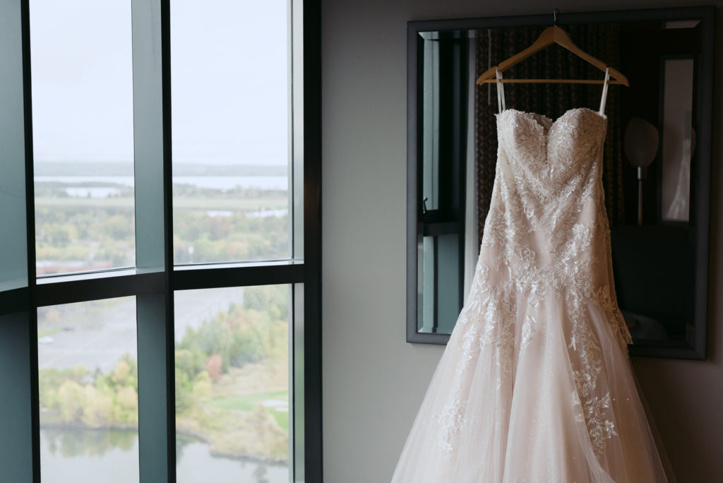 rose gold tule dress with lace overlay hanging from mirror