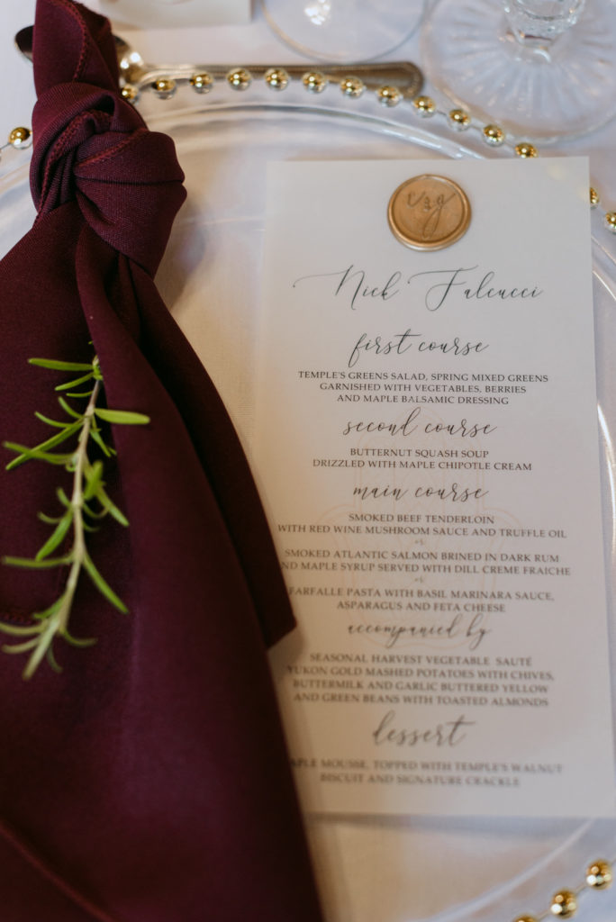 gold and marsala table setting with menu at wedding