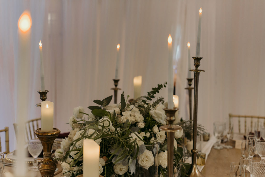 tall brass candlesticks at jewish wedding