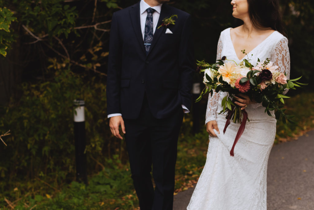 bride and groom walking down a bike path