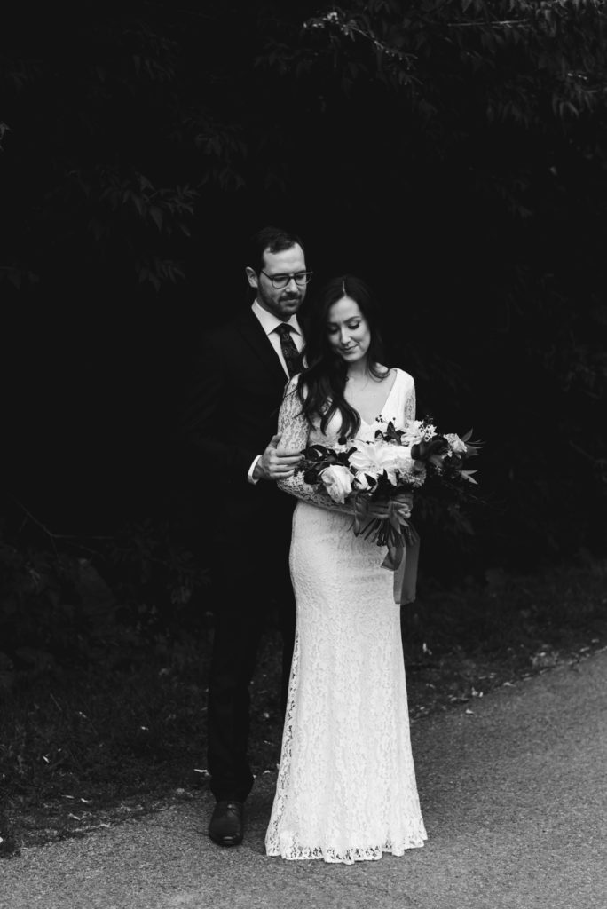 bride and groom cuddling in black and white