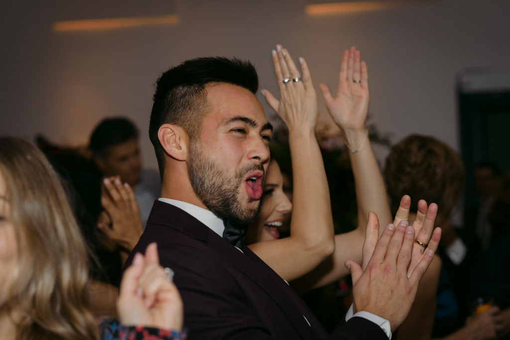 groom cheering during speeches at ottawa art gallery wedding