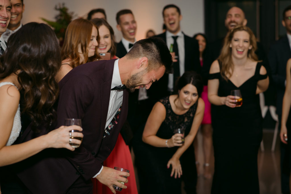 groom laughing at speeches at ottawa art gallery wedding