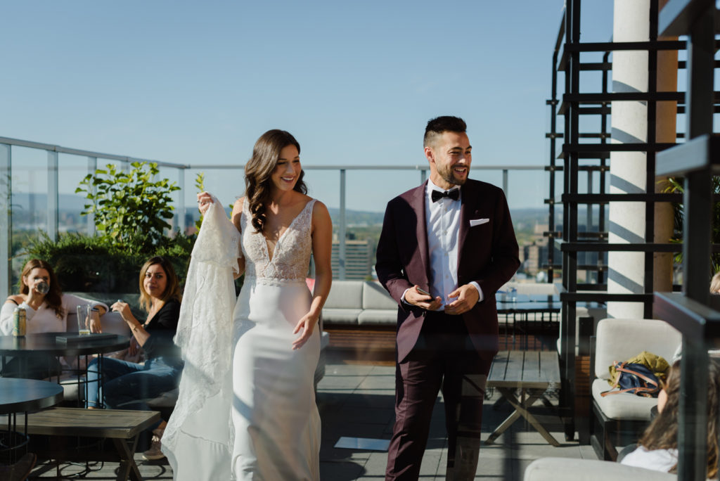 bride and groom walking on the andaz rooftop