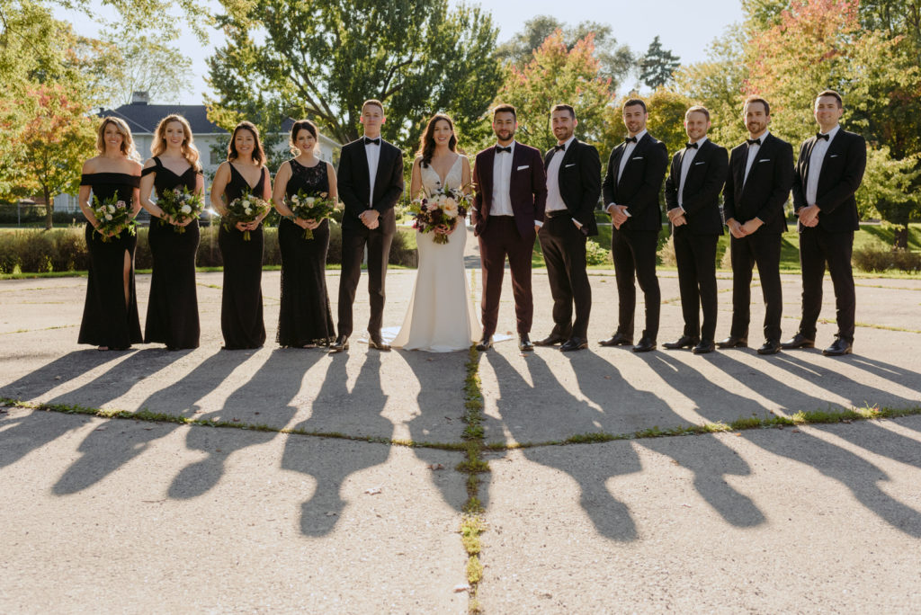wedding party in a park at sunset with shadows on the floor