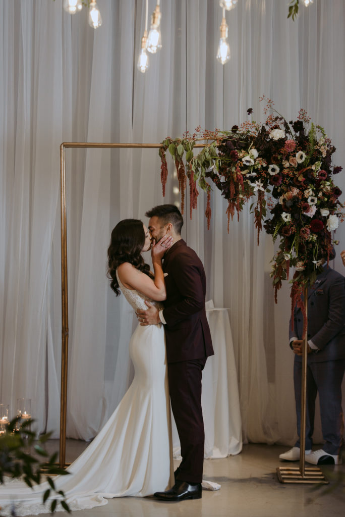 bride and groom first kiss at ottawa art gallery wedding