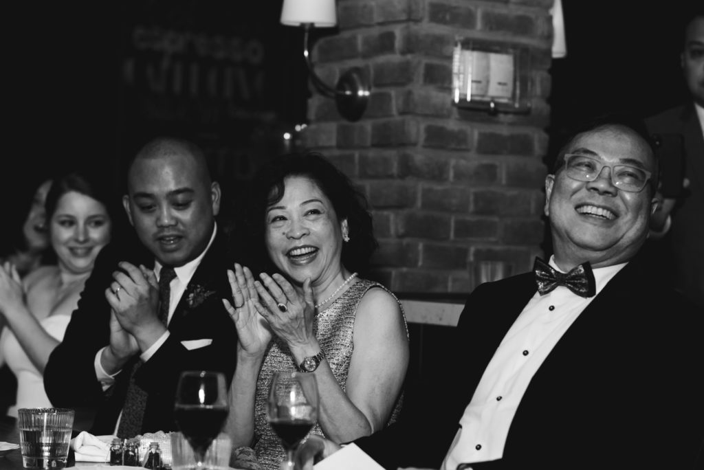 groom's parents laughing during speeches during wedding reception at the albion rooms