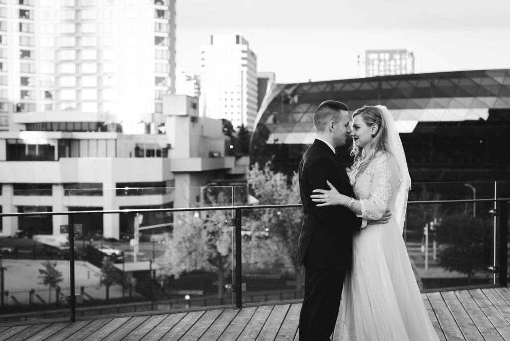 bride and groom cuddling on the NAC terrace overlooking the canal