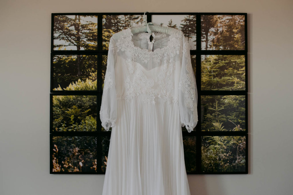 wedding dress hanging from picture frame at home