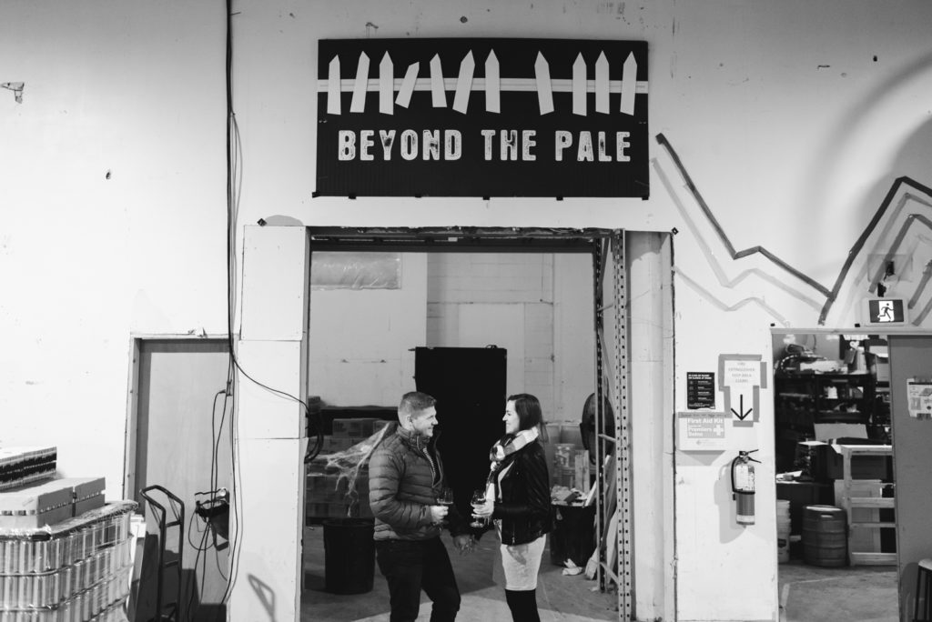 engaged couple holding hands at Beyond the Pale Brewery