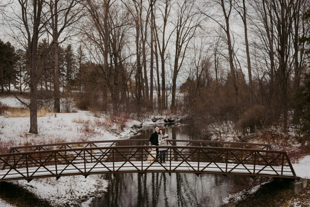 family on a bridge on a winter's day