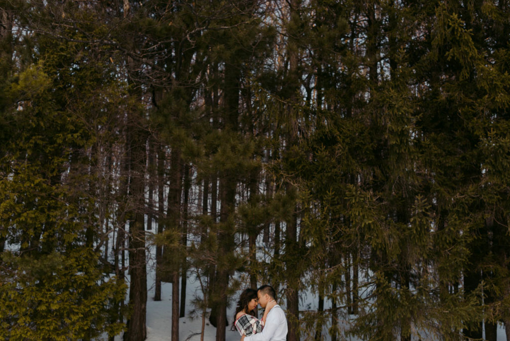 bride and groom in a forest in the winter