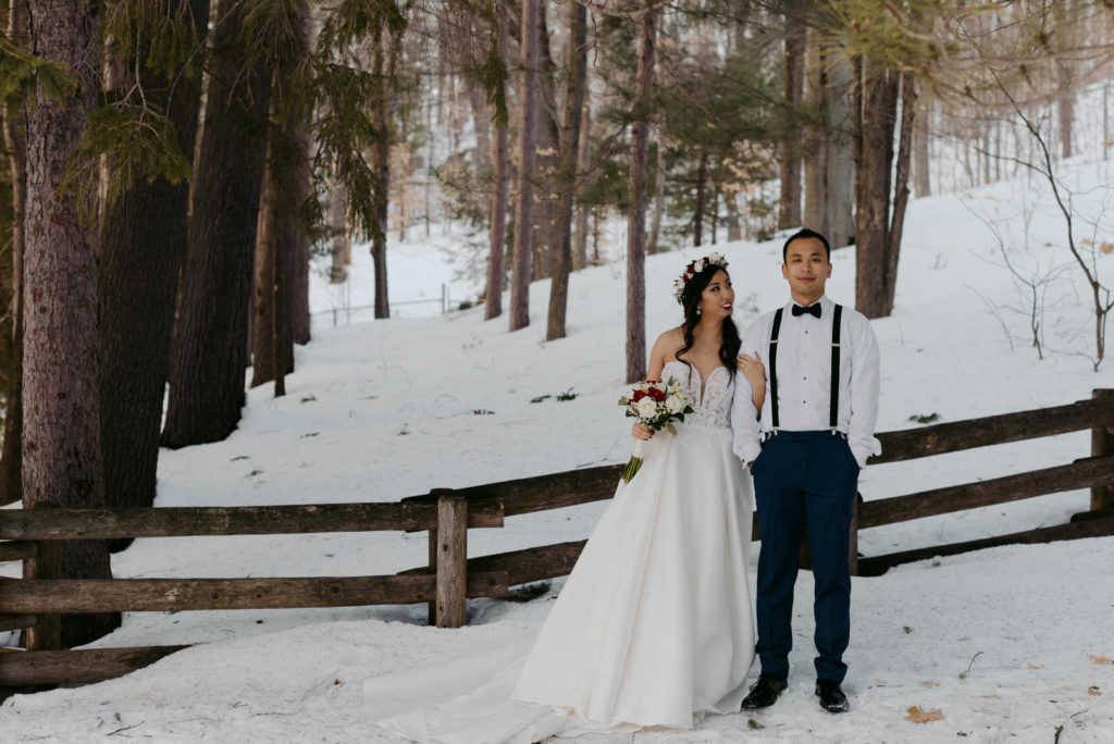 bride and groom in a forest in the winter